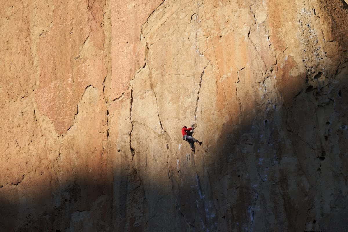 Custom rock climbing socks category cover image showing climber on a cliff face