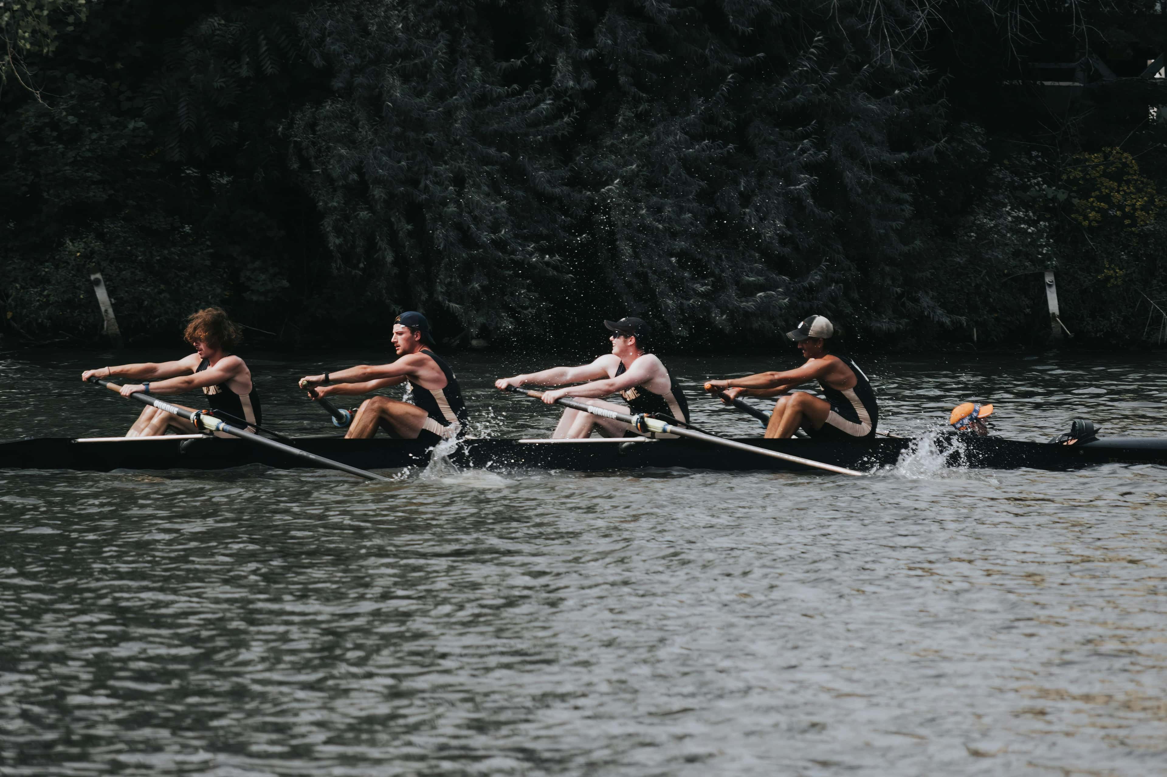 Custom rowing socks category cover image showing team training together on a river