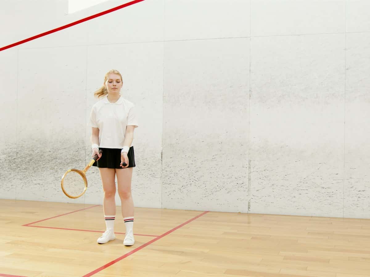 Custom squash socks category cover image showing player on an indoor court