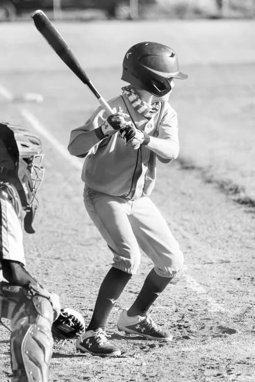 Black-and-white baseball player preparing to bat