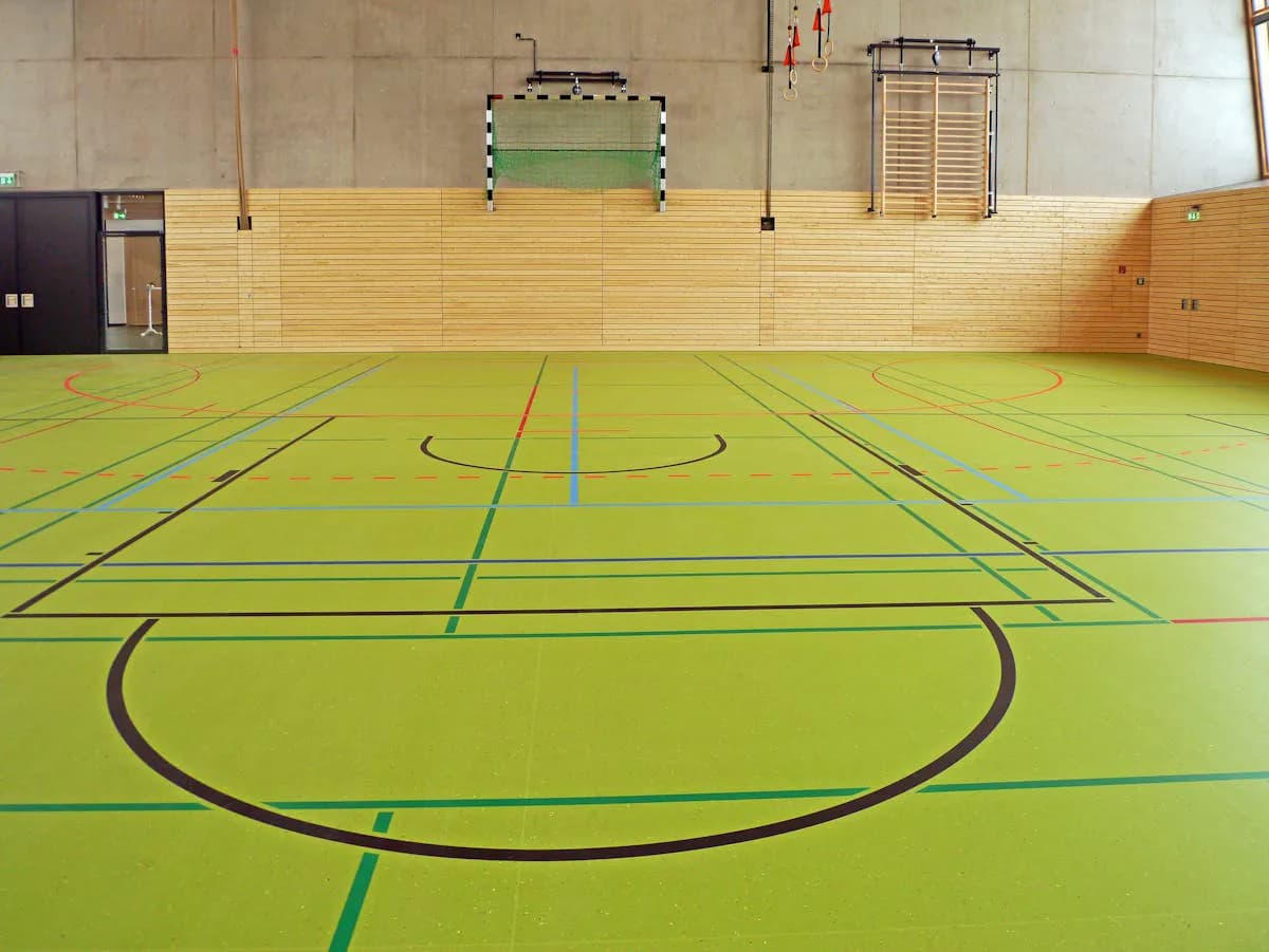 Custom handball socks category cover image showing players on an indoor court