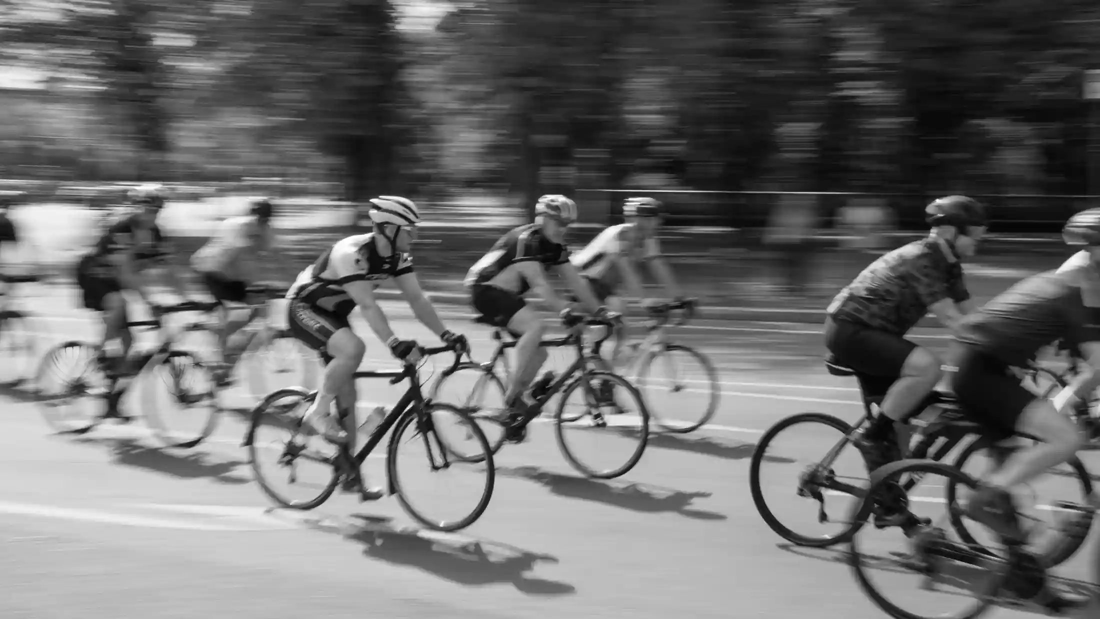 Road cyclists in motion wearing colorful kits