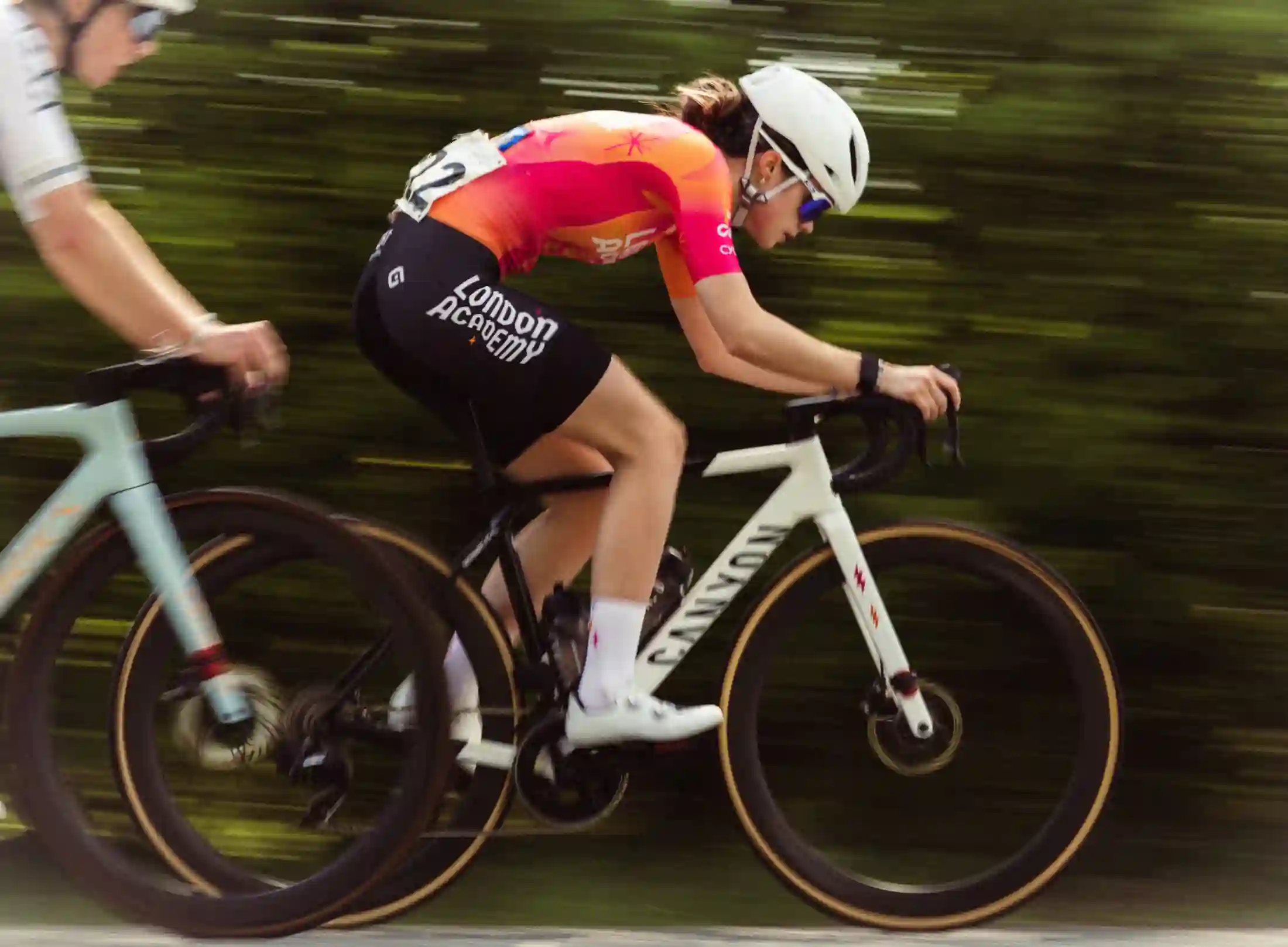 Cycling academy riders in coordinated kits