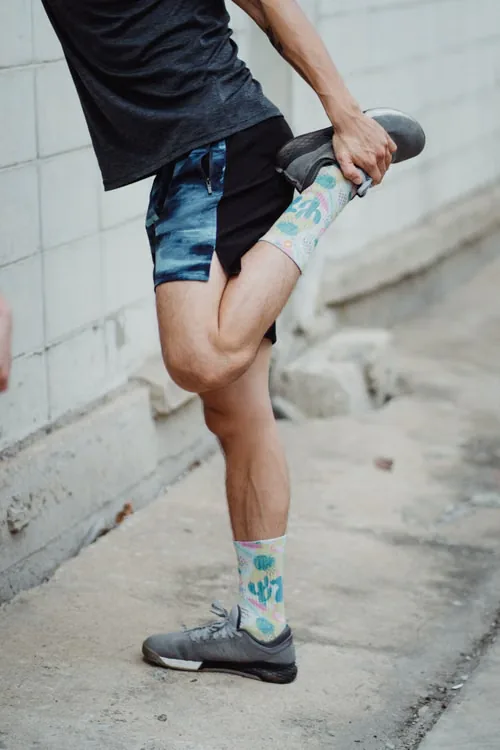 Runner stretching in colorful performance socks