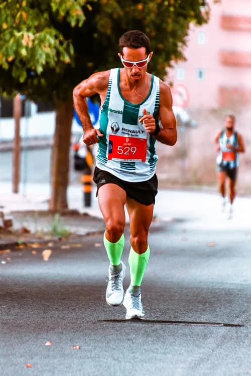 Road marathon runner wearing high-visibility green socks