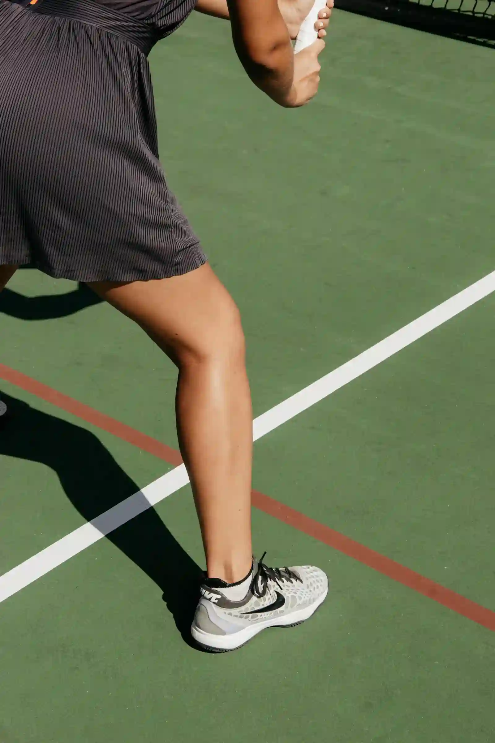 Tennis player wearing performance socks on court