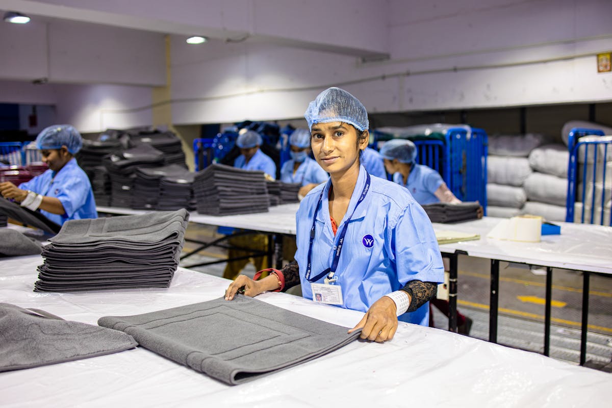 Quality inspector examining socks for defects and finish consistency during wholesale manufacturing inspection